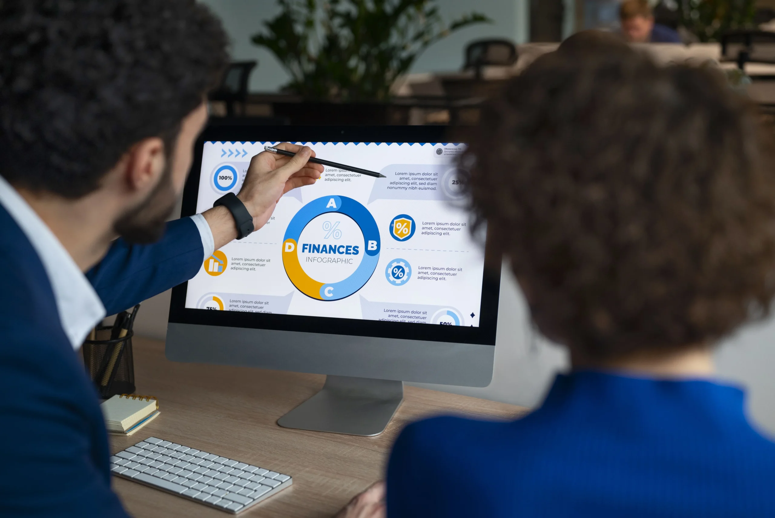Two colleagues reviewing a financial chart on a computer screen